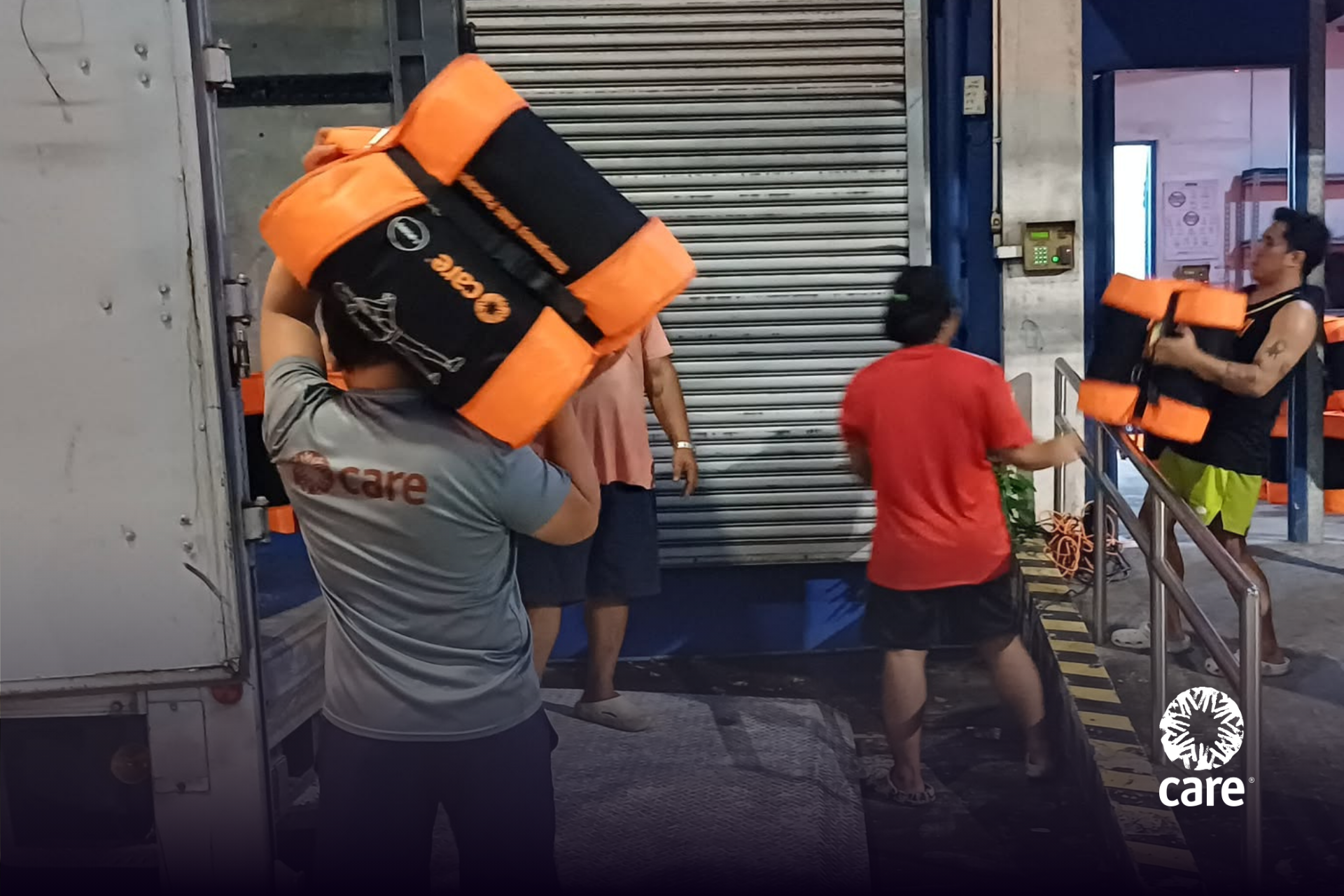 CARE staff loads an Emergency CARE Package to be delivered and distributed to typhoon-affected communities