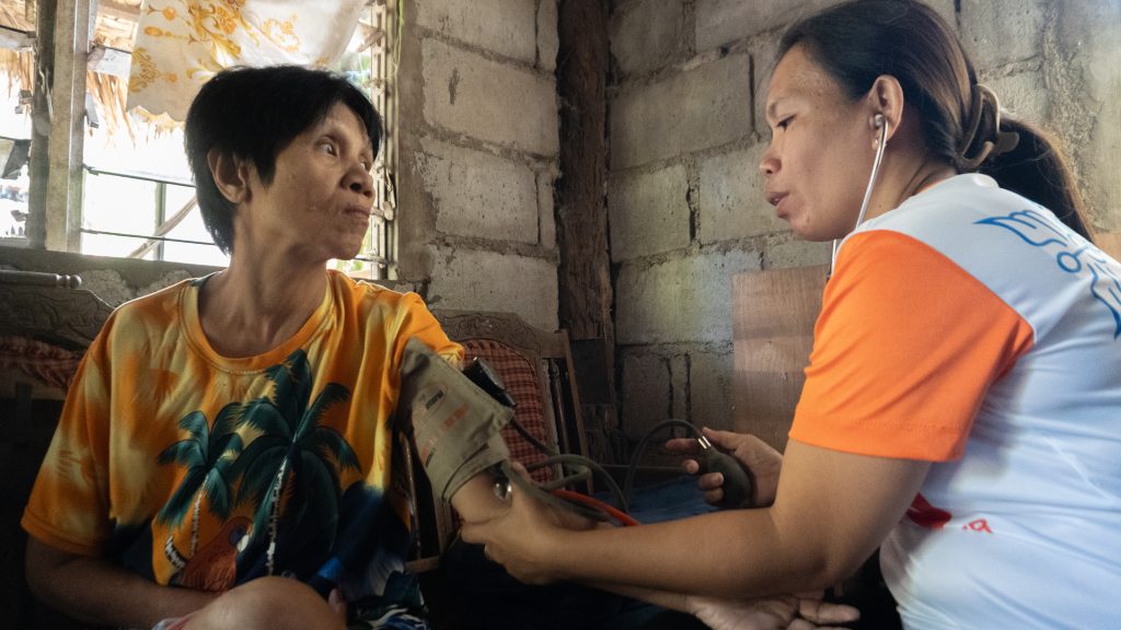 Lanie visits a patient who suffered a stroke to monitor her blood pressure level. @2026 Mary Therese Norbe/CARE
